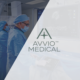 Avvio Medical logo over surgical team preparing equipment in operating room